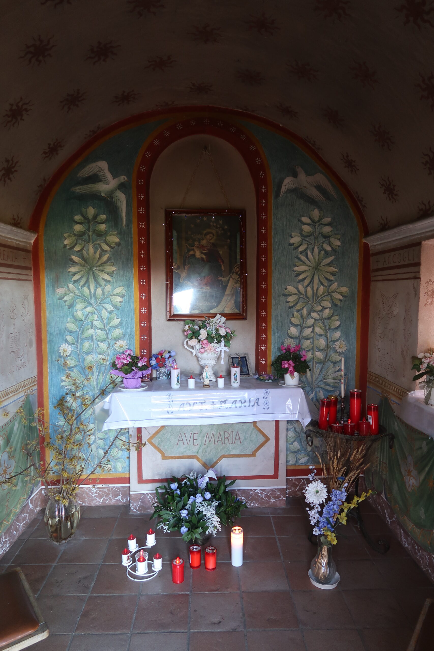 L'interno della cappelletta della Madonna di Pompei. I ceri votivi, l'altare, il quadro "miracoloso". Fotografia © di Giancarlo Nicoli.