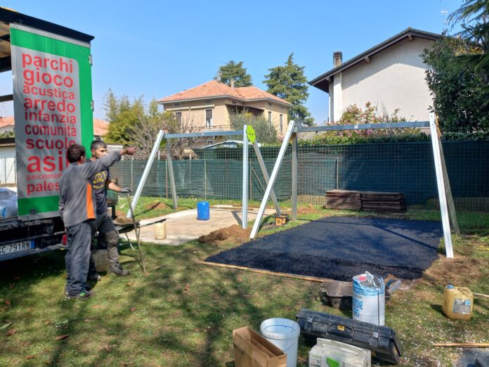 Lavori di sistemazione del parco giochi di Fenegrò. Giuseppe indica la direzione. Fotografia © Giancarlo Nicoli.